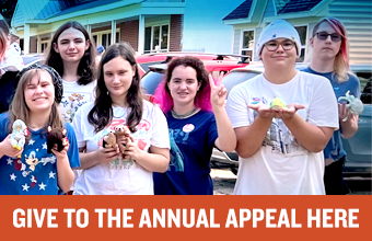 "Give to the Annual Appeal" appears in text in front of several students standing outside The New School