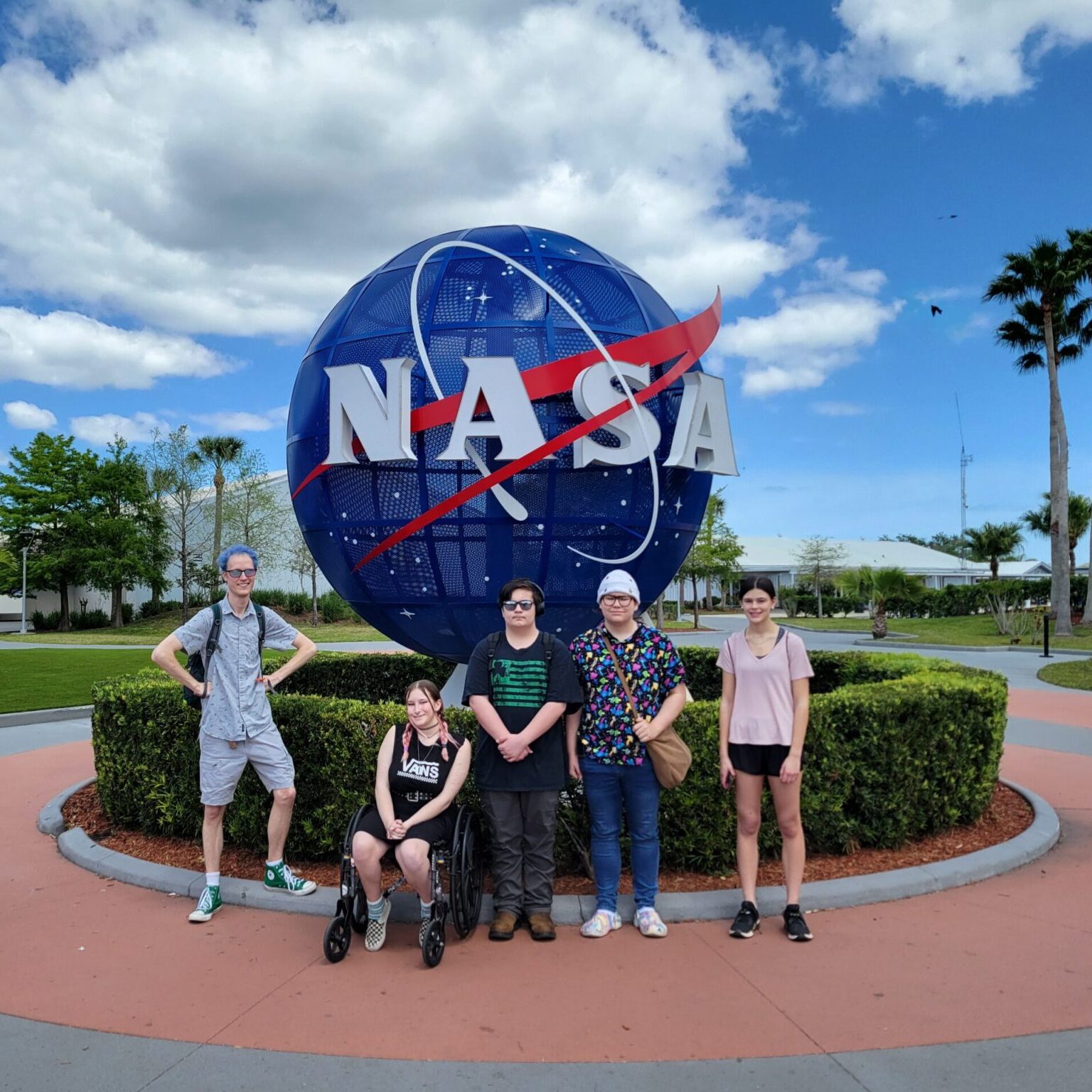 Phoenix, Olie, Cameron, Vivian, and Lilly in front of the NASA "meatball" sculpture outside Kennedy Space Center.