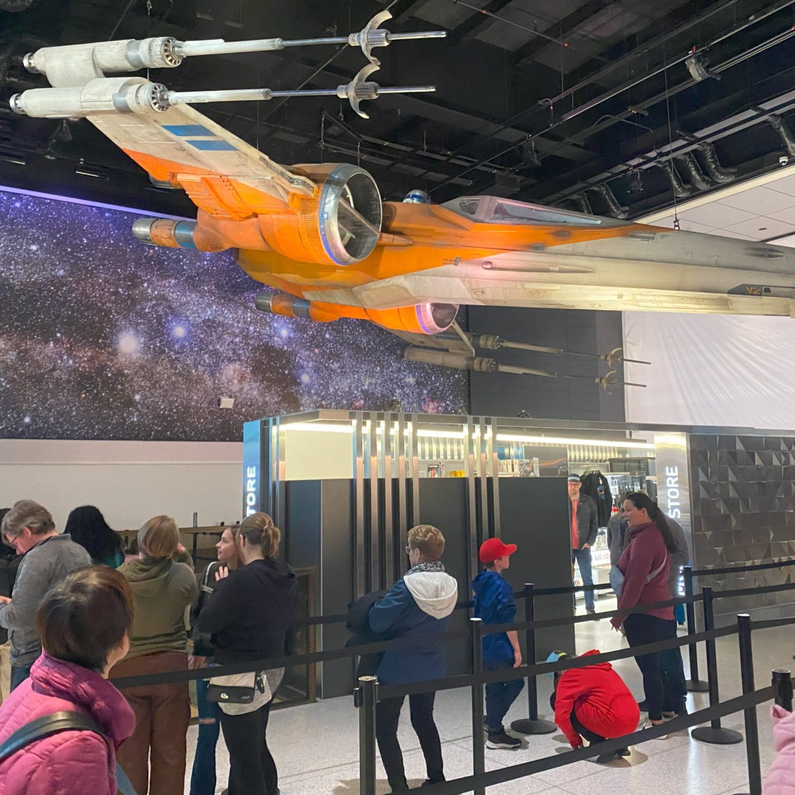 An X-Wing above visitors to the Smithsonian's National Air and Space Museum.