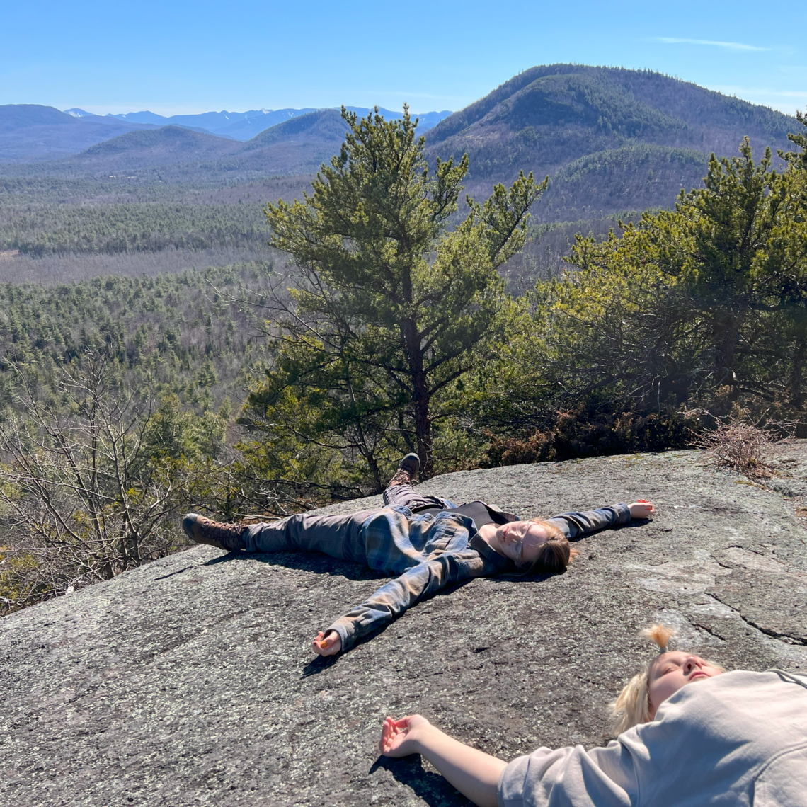 Courtlynn and Kira, collapsed on the mountaintop.