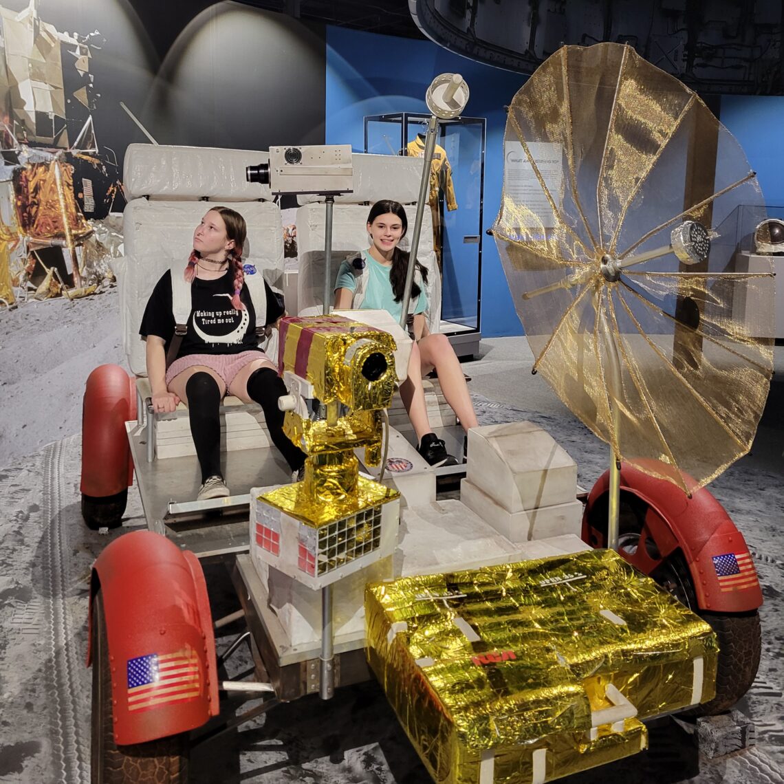 Olie and Lilly on a lunar rover at South Carolina State Museum