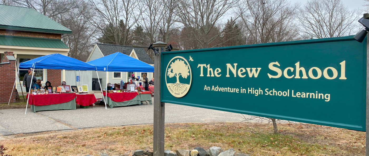 will interior an exterior shot of The New School featuring our sign and some pop-up canopies for a fair event set up around our outdoor pizza oven