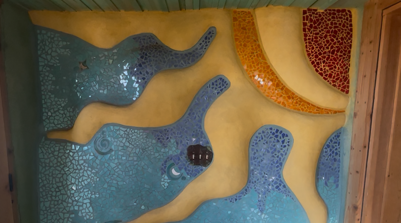 IMG_9947 cropped A sun image on a wall at the Earthship.